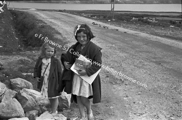 CHILDREN WAITING IN GROUP AT SIDE OF ROAD